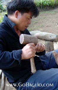 Woodcarver at work at Camp John Hay